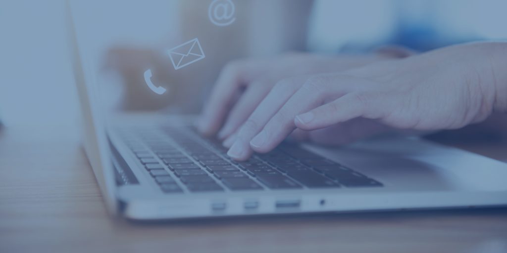 Photograph of user typing on keyboard with communication icons (phone, mail envelope) overlaid on top.