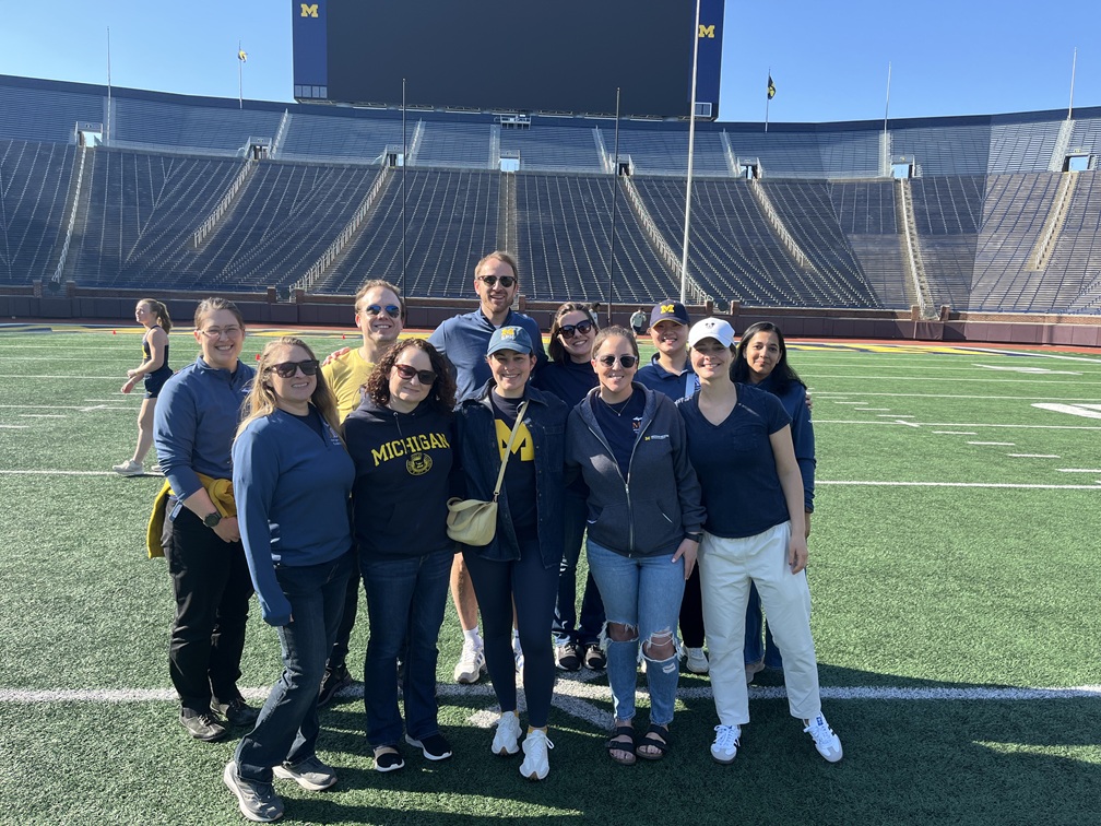 Photograph of MVC Coordinating Center team on the football field of University of Michigan "Big House"